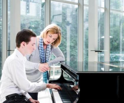 Teacher and student at a piano